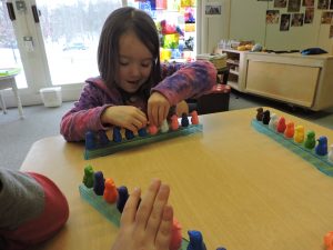 Hannah works on sorting the penguins into a pattern of colors